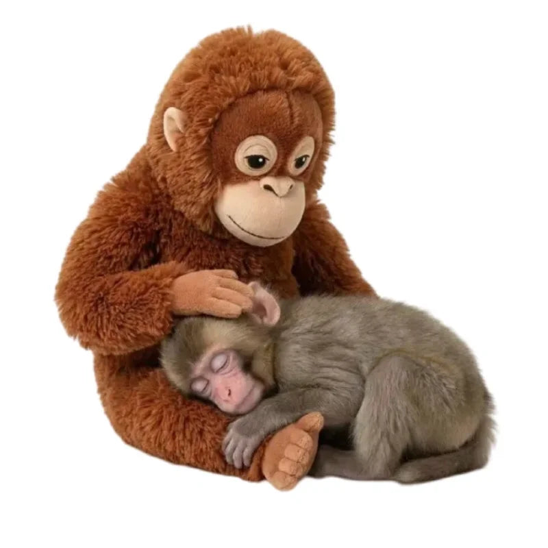 Orangutan plush cradling a sleeping baby macaque