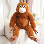 Orangutan plush sitting on a white sofa