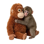 Orangutan plush hugging a baby macaque, the pose from Punch's story