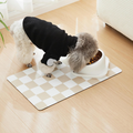 Absorbent khaki checkerboard dog feeding mat under food and water bowls