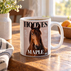White 11 oz mug with a magazine-cover pet portrait of a brown horse named Maple, steaming on a wooden kitchen table